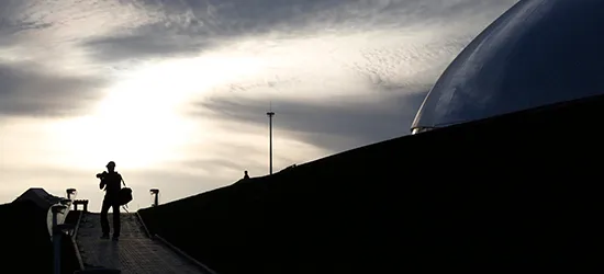 A photographer walks outside a dome built for the Sochi Games. (Reuters/Pawel Kopczynski)