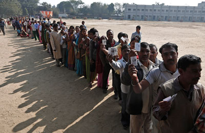 Voters queue at a polling station during the state assembly election in New Delhi on December 4, 2013. A major election is due in May. (Reuters/Adnan Abidi)