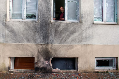 Vijesti Editor-in-Chief Mihailo Jovovic looks through a window damaged in a bomb blast at the newspaper's offices in Podgorica on December 27, 2013. (Reuters/Stevo Vasiljevic)