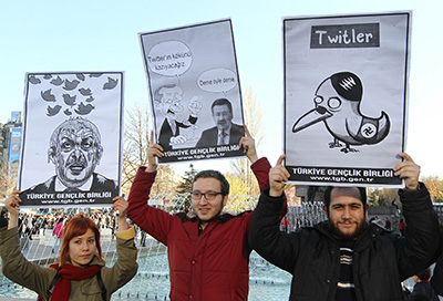 Turkish citizens hold signs protesting Twitter being blocked in the country. (AFP/Adem Altan)