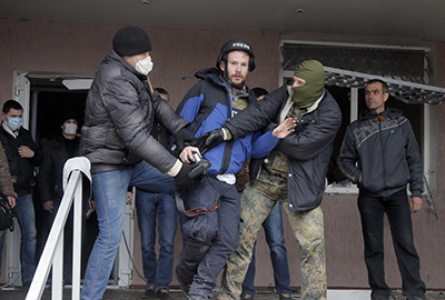 British photojournalist Frederick Paxton is roughed up while reporting in the town of Horlivka. (AP/Efrem Lukatsky)