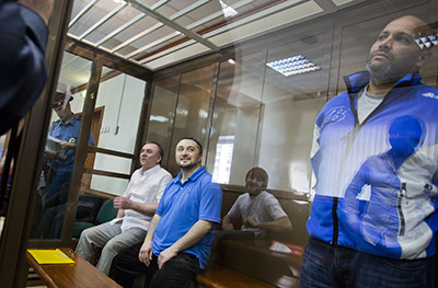 Three of the defendants--from left, Lom-Ali Gaitukayev, Rustam Makhmudov, and Sergei Khadzikhurbanov--in Moscow's City Court. (AFP/Evgeny Feldman)
