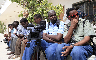 The press faces increasing risks while reporting in Somalia. Here, journalists wait during an assignment outside the presidential palace. (Reuters/Feisal Omar)