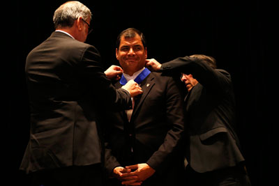 Rafael Correa is awarded an honorary doctorate by Santiago University in Chile on May 14, 2014. Four newspapers face fines for not covering the event sufficiently. (Reuters/Ivan Alvarado)