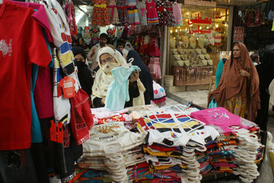 People buy garments ahead of the Eid al-Fitr holiday in Peshawar, Pakistan, on Thursday. (AP/Mohammad Sajjad)