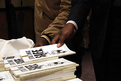 Journalists take copies of the Kenyan security manual. (Zoe Mwende)
