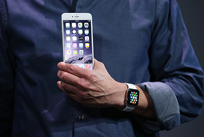 Apple chief executive Tim Cook reveals the iPhone 6 and Apple Watch in September. Apple's latest software includes automatic encryption. (Getty Images/AFP/Justin Sullivan)