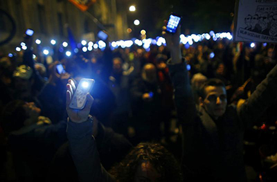 People protesting in Budapest about a new Internet tax on data use hold up their smartphones. (Reuters/Laszlo Balogh)