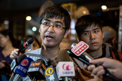 Student leaders speak to the press at a pro-democracy protest outside the central government offices in Hong Kong on Thursday. (AFP/Alex Ogle)