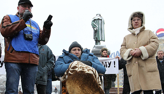 Mikhail Beketov, center, died in April 2013 from injuries he sustained in a brutal attack in 2008. Beketov had covered corruption in the Russian government. No one has been brought to justice. (AFP/Alexey Sazonov)