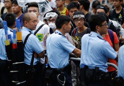 Police officers face off with protesters blocking the entrance to Hong Kong's Chief Executive Leung Chun-ying offices on Thursday. (Reuters/Carlos Barria)