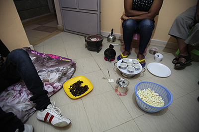 Journalists who fled to Nairobi over security fears perform a traditional Ethiopian coffee ceremony in one of the cramped apartments they share. (CPJ/Nicole Schilit)
