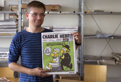 Charb, the chief editor of the the satirical weekly Charlie Hebdo, is shown holding the front page of the newspaper in 2012. Charb was shot dead today in Paris. (AFP/Fred Dufour)