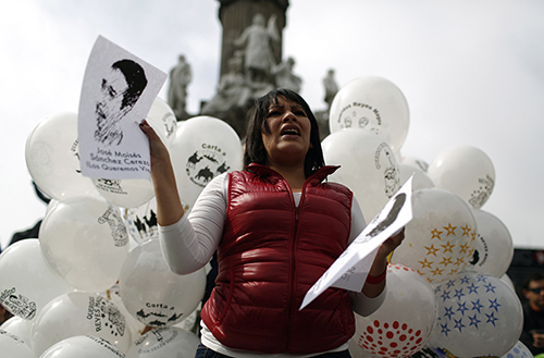 An activist holds a picture of José Moisés Sánchez Cerezo, a Mexican journalist who was kidnapped in the state of Veracruz. (Reuters/Tomas Bravo)