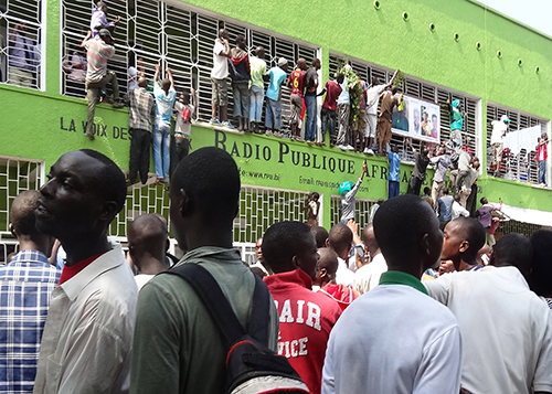 Supporters of Radio Publique Africaine director Bob Rugurika crowd around the station's offices to celebrate his release on bail last month. Rugurika's release comes as Burundi debates an easing of press laws. (AFP/Esdras Ndikumana)
