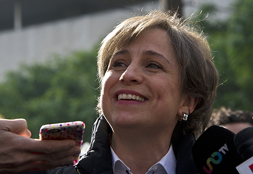Carmen Aristegui speaks to the press outside MVS Radio in Mexico City on March 16. The investigative journalist was dismissed after demanding that the station reinstate two reporters it fired last week. (AFP/Ronaldo Schemidt)