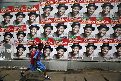 A schoolgirl walks past campaign posters for Nigerian President Goodluck Jonathan in Lagos. Journalists covering the election campaign say they are being attacked. (Reuters/ Akintunde Akinleye)