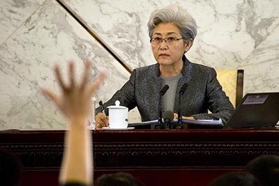 A journalist raises a hand to ask a question of Fu Ying, spokeswoman for the National People's Congress, during a press conference in Beijing. A survey of foreign journalists in China has found authorities are using delays in visa renewals to punish international correspondents for critical reports. (AP/Ng Han Guan)
