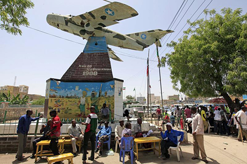 Residents sit under Somaliland's Independence memorial in Hargeisa. Journalists there say conditions are improving, but they remain wary. (Reuters/Feisal Omar)