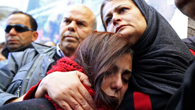 والدة المصور الصحفي نظير القطاري، يمين الصورة، الذي اختفى برفقة الصحفي سفيان شورابي في ليبيا في سبتمبر/أيلول 2014، تشارك في تظاهرة جرت في تونس في 9 يناير/كانون الثاني 2015 تضامناً مع الصحفيين المفقودين. (رويترز/ أنيس ميلي)