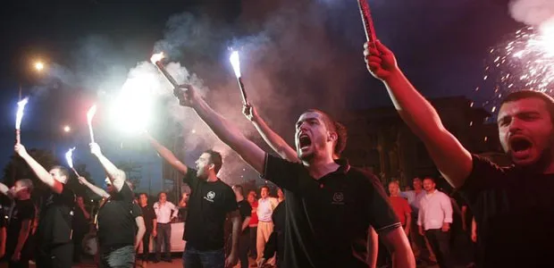 Simpatizantes do partido de extrema-direita Aurora Dourada erguem chamas para celebrar os resultados das pesquisas em Salónica, na Grécia, em 6 de maio de 2012. (Reuters / Grigoris Siamidis)