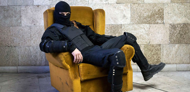 A masked pro-Russian protester poses for a photo inside a regional government building overtaken by his group in Donetsk, Ukraine, on April 25, 2014. (Reuters/Marko Djurica)