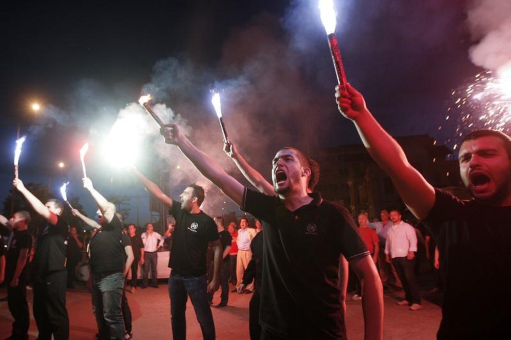 Supporters of the extreme-right Golden Dawn party raise flares as they celebrate polls results in Thessaloniki, Greece, on May 6, 2012