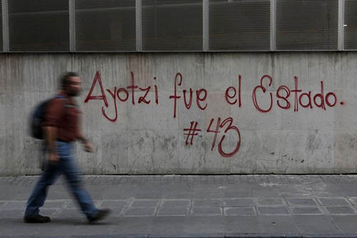 Graffiti referring to 43 students who went missing last September is spray painted on a wall in Mexico City as part of protests about their disappearance. Some journalists say they have struggled to cover the case. (Reuters/Tomas Bravo)