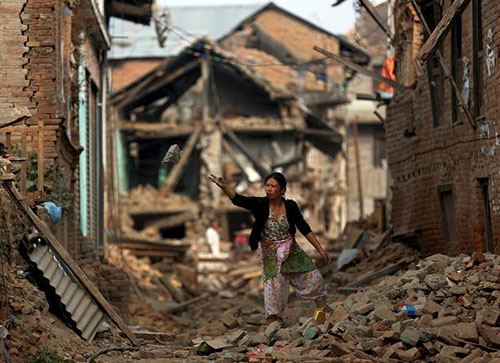 A woman clears rubble from her house outside Kathmandu. As Nepal recovers from the devastating earthquakes, local and international press can play a useful role in raising awareness of relief efforts. (Reuters/Ahmad Masood)