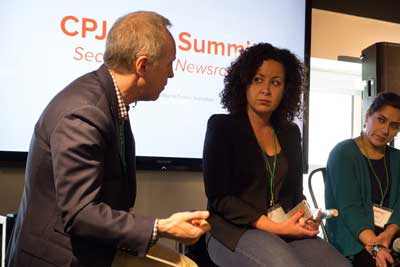 Jacob Weisberg, chairman of The Slate Group and a member of CPJ's board, left, speaks with BuzzFeed's Miriam Elder, center, and Global Voices' Sahar Habib Ghazi, right, about securing the newsroom. (CPJ/Geoffrey King)
