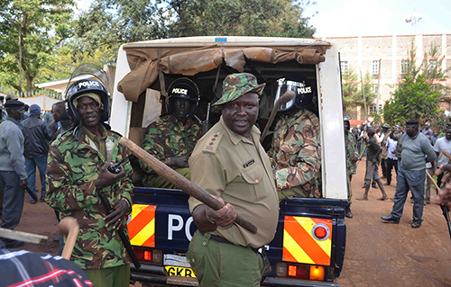 Police help protect protest organizers from a mob attack in the western Kenyan town of Kitale. (David Sirengo)