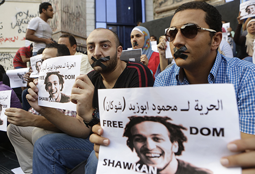 Journalists protest the imprisonment of Egyptian photographer Mahmoud Abou Zeid, or Shawkan. (AP/Amr Nabil)