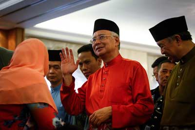 Malaysian Prime Minister Najib Razak, center, denies allegations that he received money from a state investment fund for personal use. (AP/Joshua Paul)