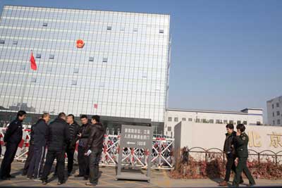 Police gather near Beijing No. 3 People's Intermediate Court where veteran journalist Gao Yu is on trial on accusations of leaking state secrets, Friday, November 21, 2014. (AP/Ng Han Guan)