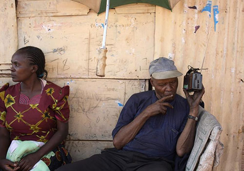 A Kenyan listens to the latest election results on a radio in 2013. More than 115 stations broadcast across the country. (Reuters/Siegfried Modola)