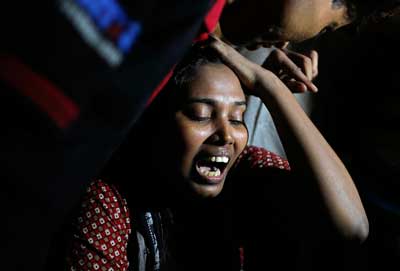Ashamoni, wife of blogger Niloy Neel, cries at her house in Dhaka Friday. (AP/A.M. Ahad)