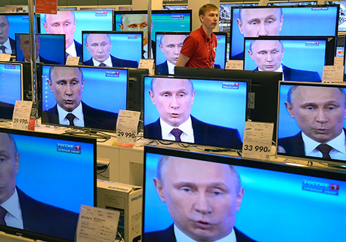 Television screens show Vladimir Putin. The EU is investigating ways to counter Russian propaganda by providing alternatives to state-run broadcasting. (AFP/Alexander Nemenov)