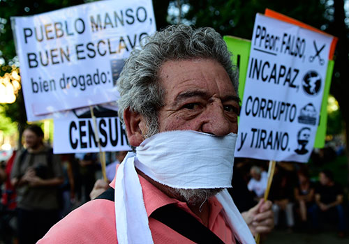 A protester with a bandanna wrapped around his mouth protests Spain’s gag law. Privacy concerns are often used as an excuse to pass restrictive legislation. (AFP/Pierre-Philippe Marcou)