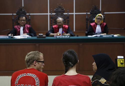 Neil Bonner and Rebecca Prosser, center, in court in Indonesia in October. The British filmmakers were sentenced for visa violations on November 3. (Reuters/Beawiharta)