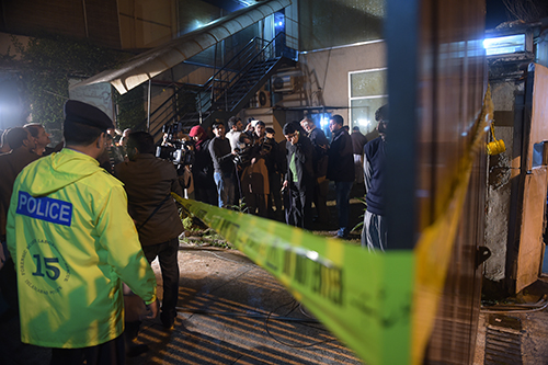 Press and police gather outside ARY News in Islamabad after a grenade attack on the privately owned Pakistani channel. (AFP/Aamir Qureshi)