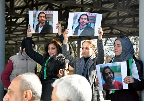 Pictures of filmmaker Naji Jerf are held up at his funeral in Gaziantep in December. Syrian media activists based in Turkey say the murder of Jerf and two other journalists makes the country feels less secure. (STR/AFP)