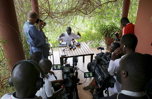 Ugandan opposition leader Kizza Besigye, who is under house arrest, speaks during a news conference at his home on the outskirts of Kampala, the capital, on February 21. (Reuters/Goran Tomasevic)