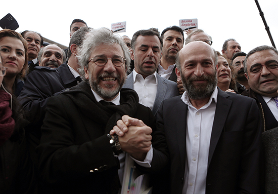 Can Dündar, left, and Erdem Gül speak to reporters before standing trial in Istanbul, March 25, 2016. (AP)