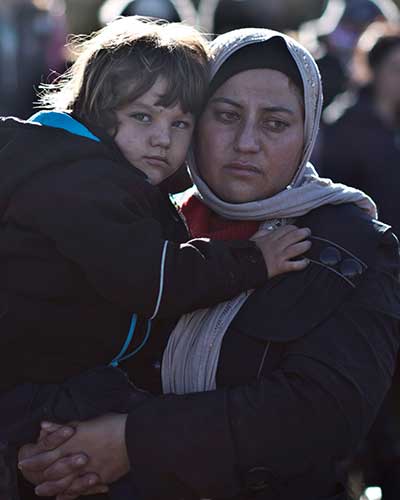 A Yazidi refugee from Iraq holds her child shortly after arriving on the Greek island of Lesbos in November 2015. The author found children most likely to give honest answers to reporters. (AP/Muhammed Muheisen)