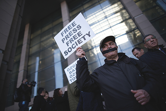 Journalists cover their mouths to protest the April 1, 2016, trial of Cumhuriyet journalists in Istanbul. (Emrah Gurel/AP)