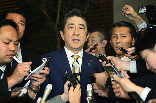 Reporters surround Japanese Prime Minister Shinzo Abe in February. Journalists say control of the media has been tightened since he came to power. (AFP/Jiji Press)