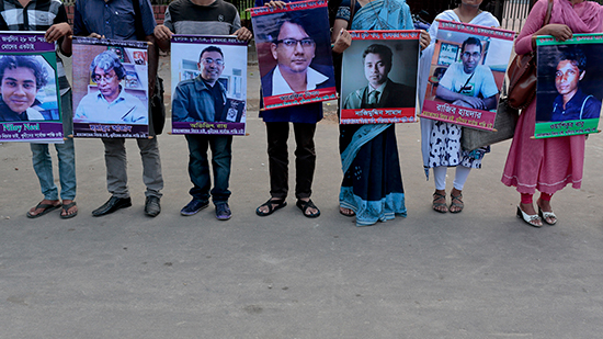 Demonstrators hold pictures of those killed by violent extremists in Dhaka, June 15, 2016. (AP)