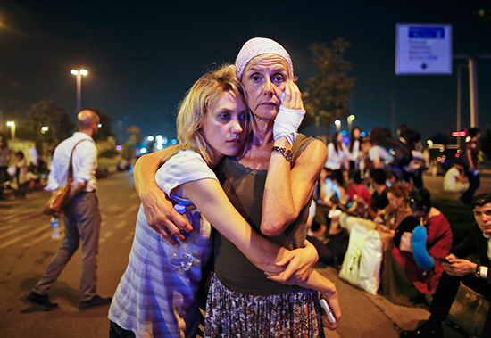 Travelers embrace after gun and bomb attacks at Istanbul's Ataturk Airport killed at least 41 people and injured 239 more, June 28, 2016. (Emrah Gurel/AP)