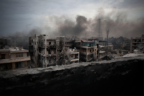Smoke rises over Aleppo's Saif al-Dawla district in this October 2, 2012, file photo. (Manu Brabo/AP)
