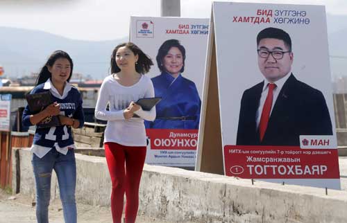 Women walk past posters of candidates from the Mongolian People's Party on the outskirts of the capital, Ulaanbaatar, on June 27, 2016. The election on June 29 is unlikely to have a strong impact on press freedom in Mongolia. (Reuters/Jason Lee)